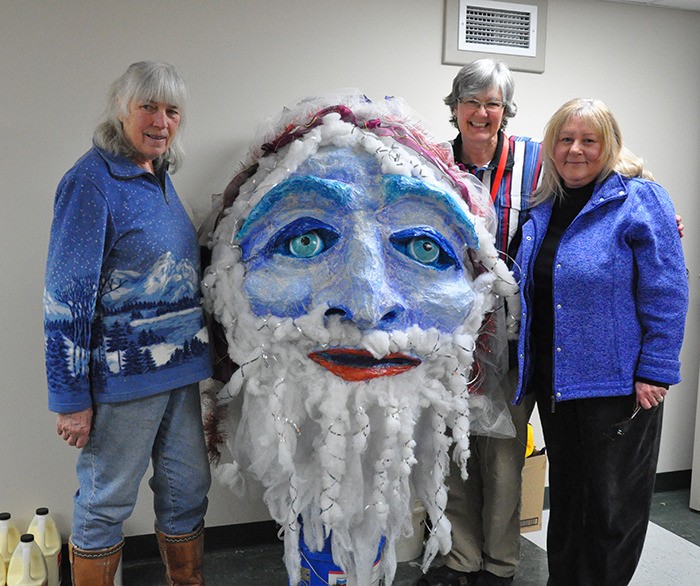 Creators of the original Snow King puppet Erica Thadeour (left) and Dawnita Johnson (right) pose with the head they made 10 years ago. Joyce deBoer (centre) was also around for the very first Snow King Masque Parade