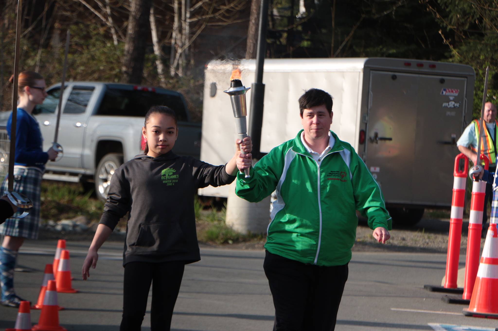 Gymnast Brooklyn Stobbe and bowler Jenny Scholefield bring in the torch to begin the 100-day countdown to the 2018 B.C. Summer Games in the Cowichan Valley. (Kevin Rothbauer/Citizen)