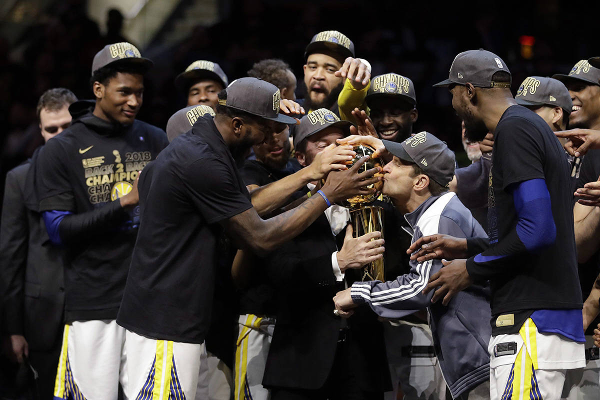 Golden State Warriors co-owner Peter Guber kisses the trophy after the Warriors defeated the Cleveland Cavaliers 108-85 in Game 4 of basketball’s NBA Finals to win the NBA championship, Friday, June 8, 2018, in Cleveland. (AP Photo/Tony Dejak)