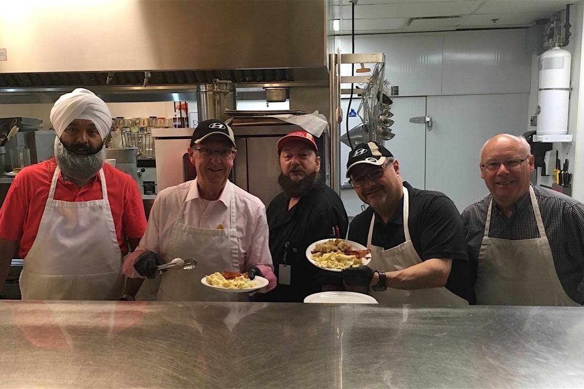Surrey Centre MP Randeep S. Sarai, South Surrey-White Rock MP Gordie Hogg, Pitt Meadows-Maple Ridge MP Dan Ruimy and Fleetwood-Port Kells MP Ken Hardie help serve breakfast at Our Place shelter in Victoria, July 8, 2018. (Twitter)