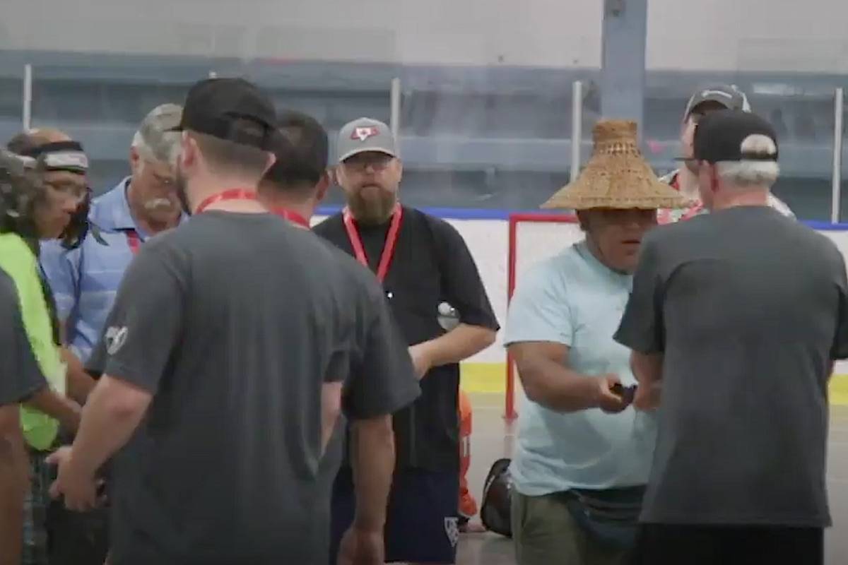 Lacrosse coaches take part in a ceremonial blessing before a game at the 2018 BC Summer Games in the Cowichan Valley.
