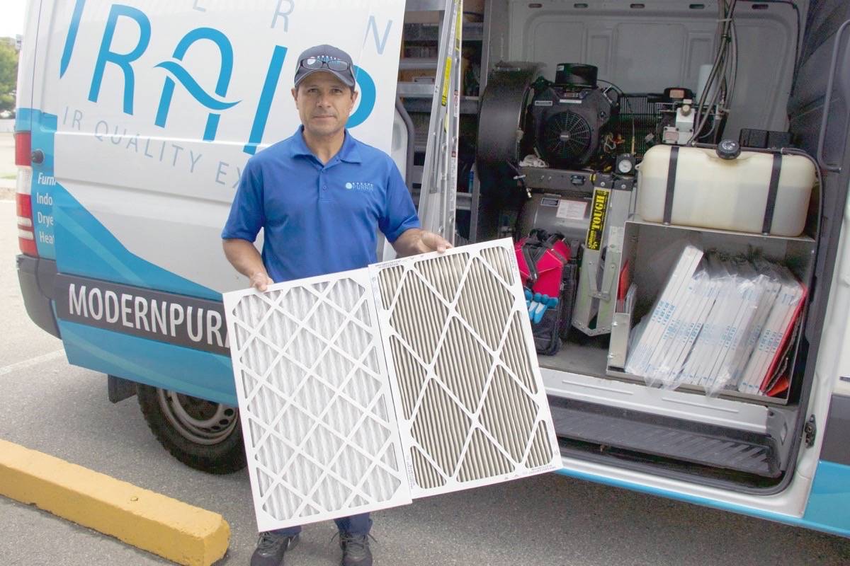 Enrique Quesada, Manager of Vernon Modern Purair franchise, shows off the difference between a new filter and a one-month-old filter that had been exposed to Okanagan smoky skies. (Brieanna Charlebois/Morning Star)