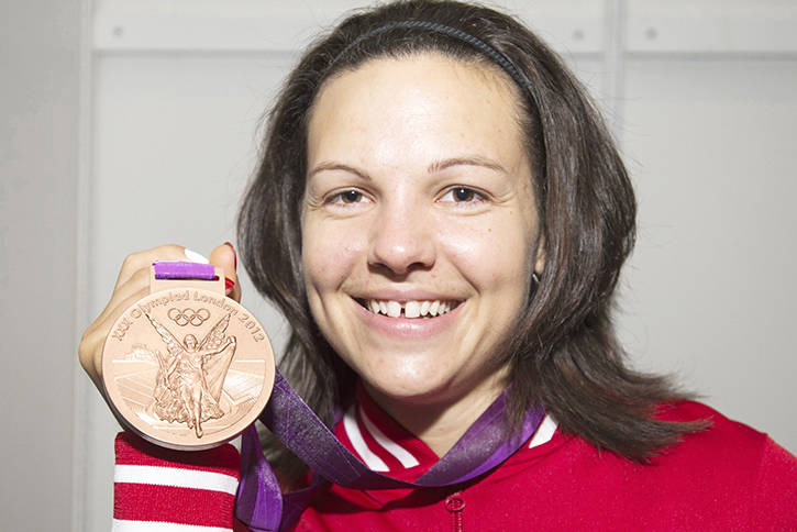 Christine Girard holds her bronze medal from 2012, which has now been officially upgraded to gold. (File photo)