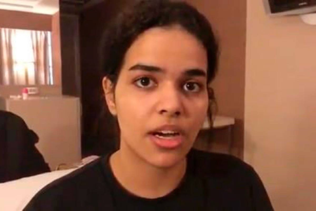 In this Monday, Jan. 7, 2019, image made from video released by Rahaf Mohammed Alqunun/Human Rights Watch, Rahaf Mohammed Alqunan views her mobile phone as she sits barricaded in a hotel room at an international airport in Bangkok, Thailand. AlqunUn says she is fleeing abuse by her family and wants asylum in Australia. (Rahaf Mohammed Alqunun/Human Rights Watch via AP)