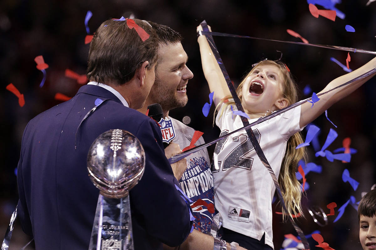 New England Patriots’ Tom Brady holds his daughter, Vivian, after the NFL Super Bowl 53 football game against the Los Angeles Rams, Sunday, Feb. 3, 2019, in Atlanta. The Patriots won 13-3. (AP Photo/Mark Humphrey)