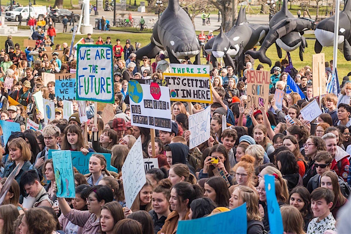 Students gather at the B.C. legislature for a Friday afternoon “climate strike,” March 15, 2019. Plastic orcas are a regular feature of anti-pipeline protests there. (Keri Coles/Black Press Media)