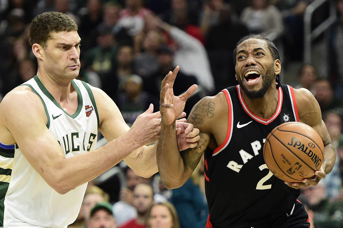 Toronto Raptors forward Kawhi Leonard (2) reacts while he holds the ball as Milwaukee Bucks centre Brook Lopez (11) looks on during second half Game 2 of the NBA basketball Eastern Conference finals in Milwaukee on Friday, May 17, 2019. THE CANADIAN PRESS/Frank Gunn