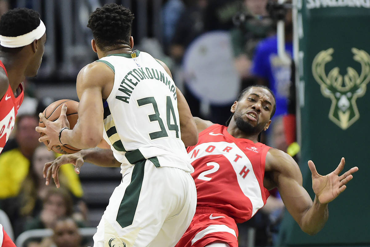 Toronto Raptors forward Kawhi Leonard (2) is called for a defensive foul against Milwaukee Bucks forward Giannis Antetokounmpo (34) during second half action in Game 5 of the NBA Eastern Conference final in Milwaukee on Thursday, May 23, 2019. THE CANADIAN PRESS/Frank Gunn