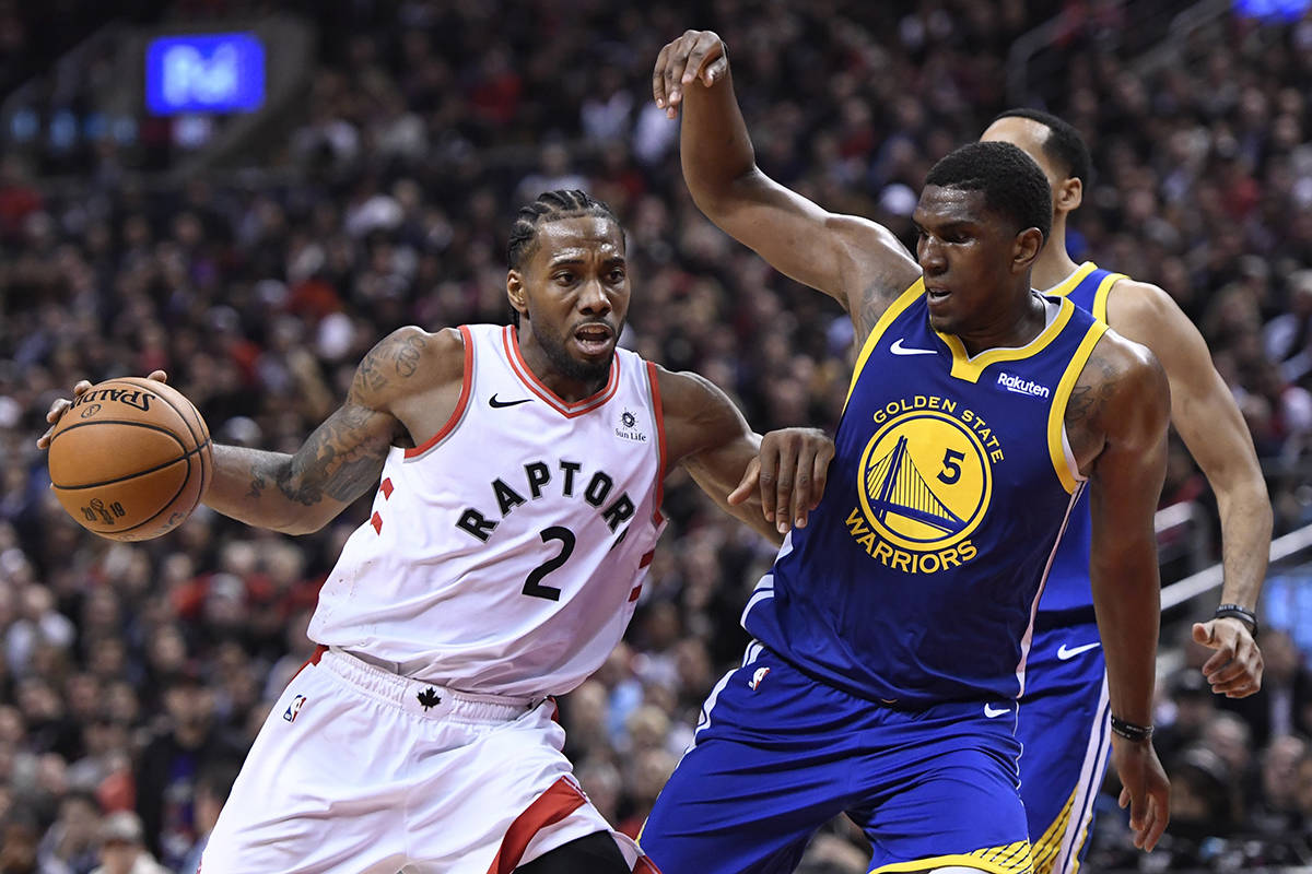 Toronto Raptors forward Kawhi Leonard (2) drives up court as Golden State Warriors centre Kevon Looney (5) defends during second half basketball action in Game 1 of the NBA Finals in Toronto on Thursday, May 30, 2019. THE CANADIAN PRESS/Frank Gunn