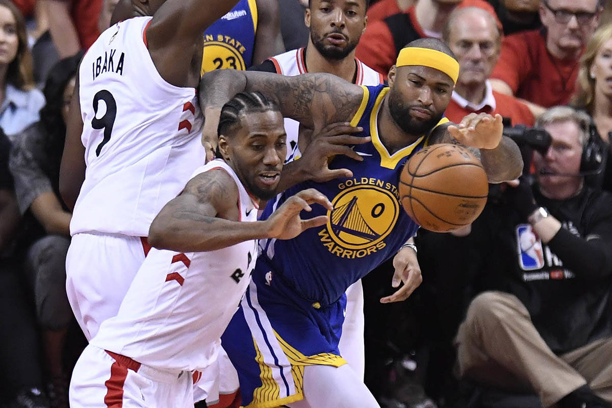 Toronto Raptors forward Kawhi Leonard (2) pushes off Golden State Warriors centre DeMarcus Cousins (0) during second half basketball action in Game 5 of the NBA Finals in Toronto on Monday, June 10, 2019. THE CANADIAN PRESS/Frank Gunn