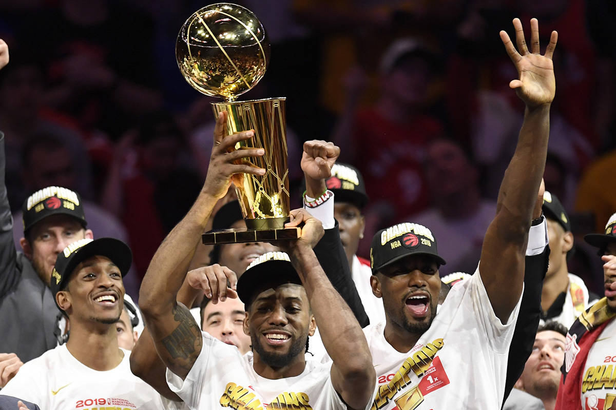 Toronto Raptors forward Kawhi Leonard, centre, holds Larry O’Brien NBA Championship Trophy after defeating the Golden State Warriors basketball action in Game 6 of the NBA Finals in Oakland, Calif. on Thursday, June 13, 2019. Raptors have won their first NBA title in franchise history. THE CANADIAN PRESS/Frank Gunn