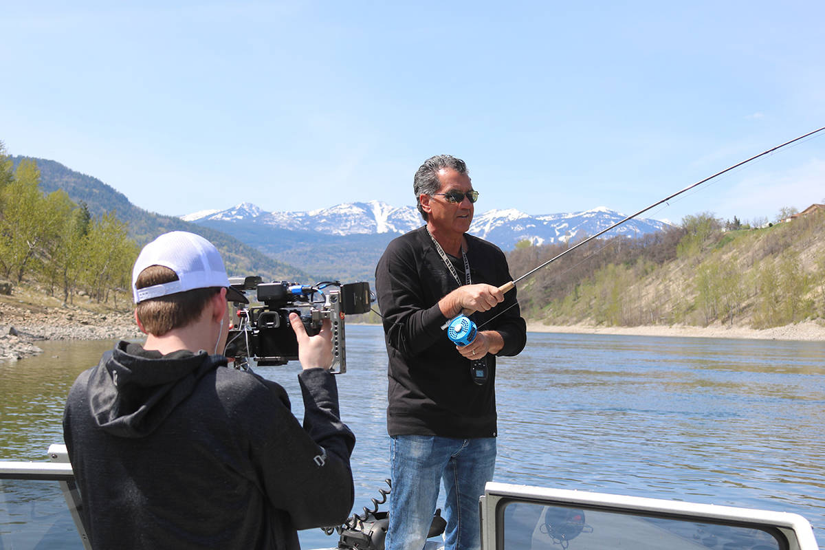 Trail videographer Jordan Stobel films “Sport Fishing on the Fly” host Don Freschi fighting a rainbow on the Columbia River with the slopes of Red Mountain looming in the background. Freschi is launching ontheflyadventures.ca this coming week, a portal to many of Freschi’s ultimate fly-fishing experiences.  Jim Bailey photo