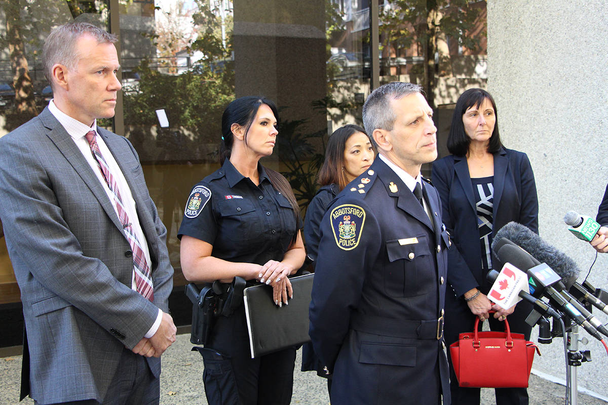 Abbotsford Police Chief Mike Serr, surrounded by members of the Abbotsford Police Department, responds to media questions outside of the New Westminster courthouse on Thursday, following the verdict in the trial of Oscar Arfmann. (Vikki Hopes/Abbotsford News)
