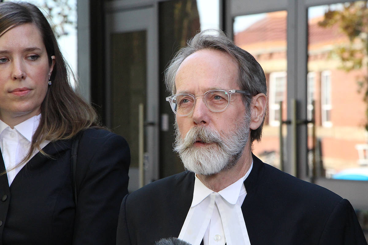 Defence lawyer Martin Peters, with co-counsel Frances Mahon, responds to media questions outside of the New Westminster courthouse on Thursday, following the verdict in the trial of Oscar Arfmann. (Vikki Hopes/Abbotsford News)