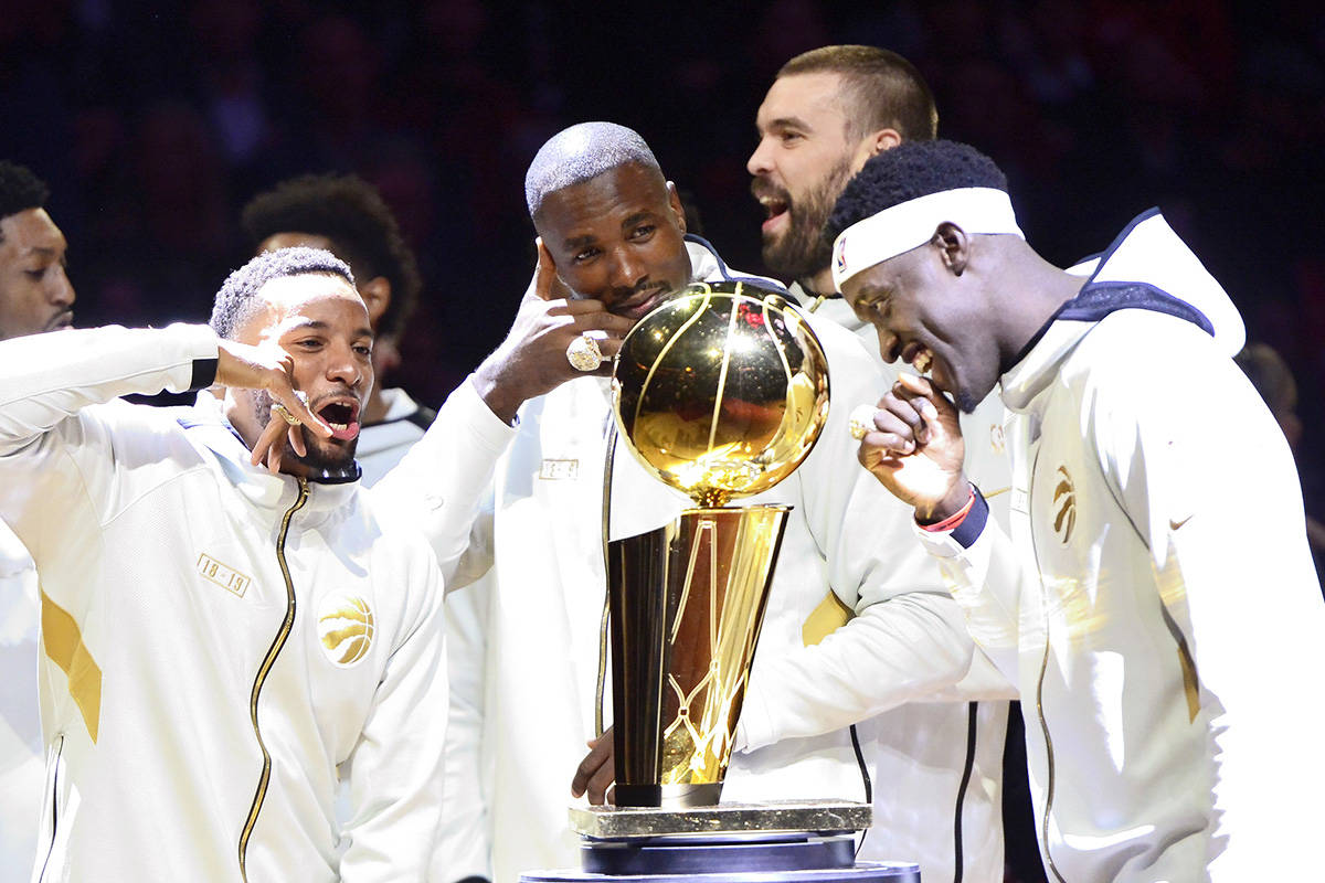 Toronto Raptors players Norman Powell, left to right, Serge Ibaka, Marc Gasol and Pascal Siakam stand with their rings behind the Larry O’Brien NBA Championship Trophy before playing the New Orleans Pelicans in Toronto on Tuesday Oct. 22, 2019. The Raptors defeated the Golden State Warriors last spring in a six-game final to win the NBA title for the first time in franchise history. THE CANADIAN PRESS/Frank Gunn