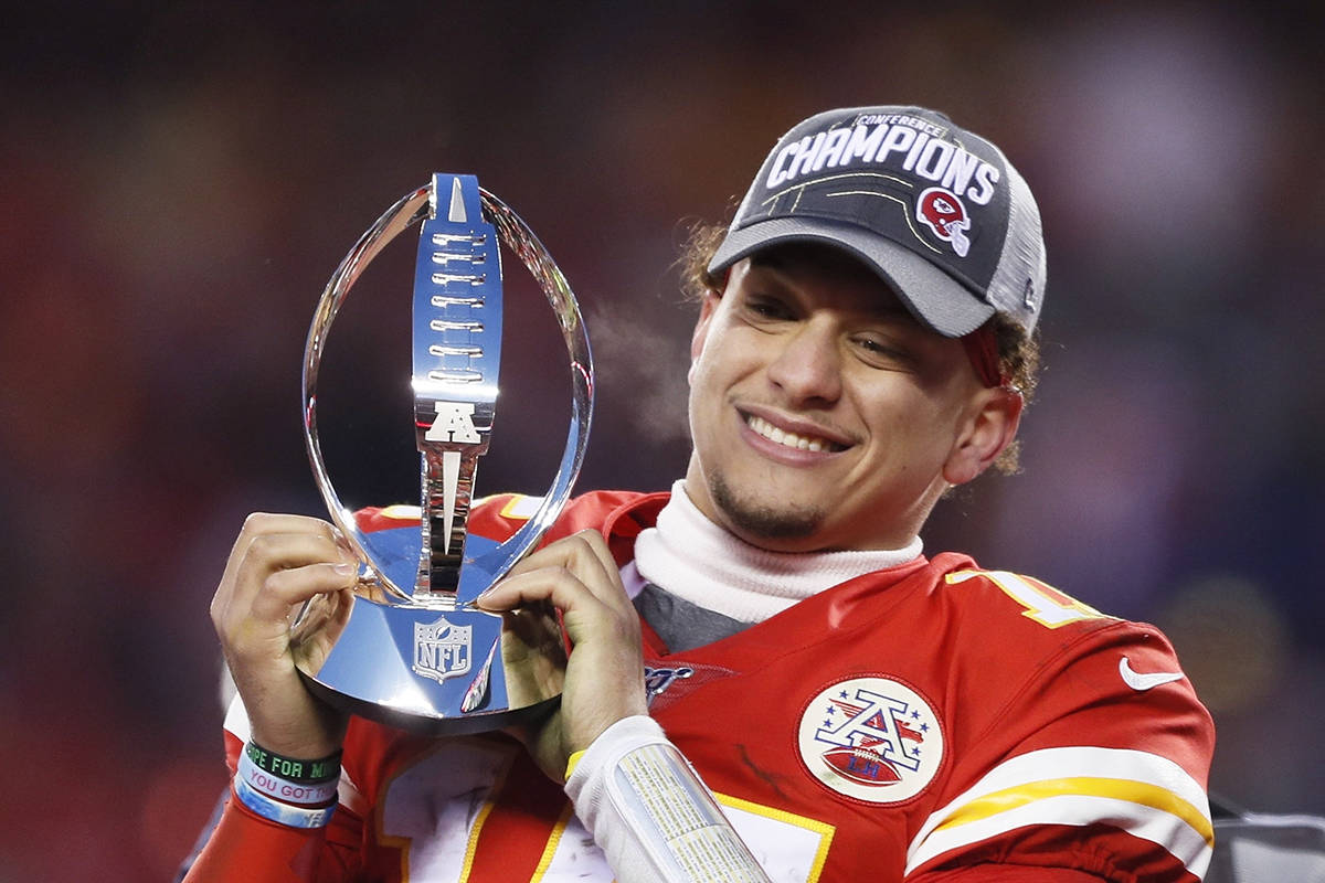 Kansas City Chiefs’ Patrick Mahomes celebrates with the Lamar Hunt Trophy after the NFL AFC Championship football game against the Tennessee Titans Sunday, Jan. 19, 2020, in Kansas City, Mo. The Chiefs won 35-24 to advance to Super Bowl 54. (AP Photo/Charlie Neibergall)