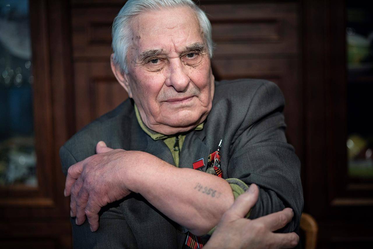 Yevgeny Kovalev, one of the Auschwitz concentration camp’s survivors, shows the camp’s identification number tattooed on his arm, during an interview with the Associated Press at his flat in Moscow, Russia. (AP Photo/Alexander Zemlianichenko)