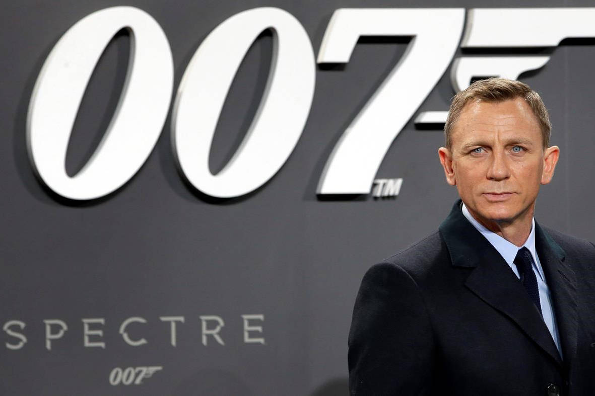 FILE - This is a Wednesday, Oct. 28, 2015 file photo of actor Daniel Craig poses for the media as he arrives for the German premiere of the James Bond movie ‘Spectre’ in Berlin, Germany. The release of the James Bond film “No Time To Die” has been pushed back several months because of global concerns about coronavirus. (AP Photo/Michael Sohn/File)