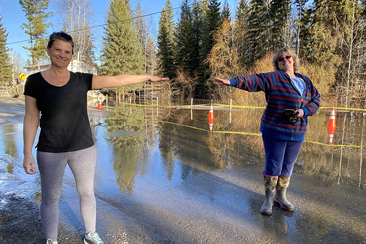 Wildwood neighbours Cheryl Michalchuk and Marion Bremner social distance while getting to know each other better in the face of spring flooding. (Angie Mindus photo - Williams Lake Tribune)