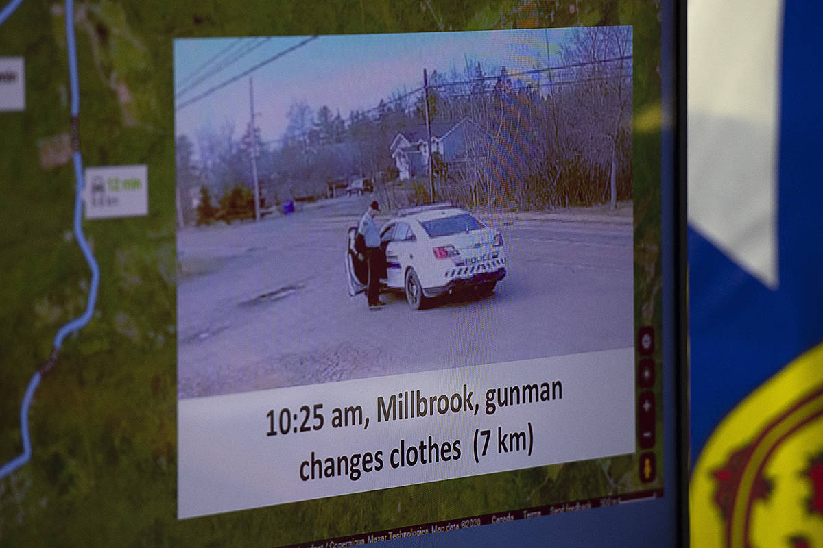 This photo showing the gunman changing clothes beside a replica RCMP vehicle is displayed at a media briefing RCMP headquarters in Dartmouth, N.S., Tuesday, April 28, 2020. The Nova Scotia RCMP say the replica police car driven by a gunman who killed 22 people this month was obtained in the fall of 2019. THE CANADIAN PRESS/Andrew Vaughan