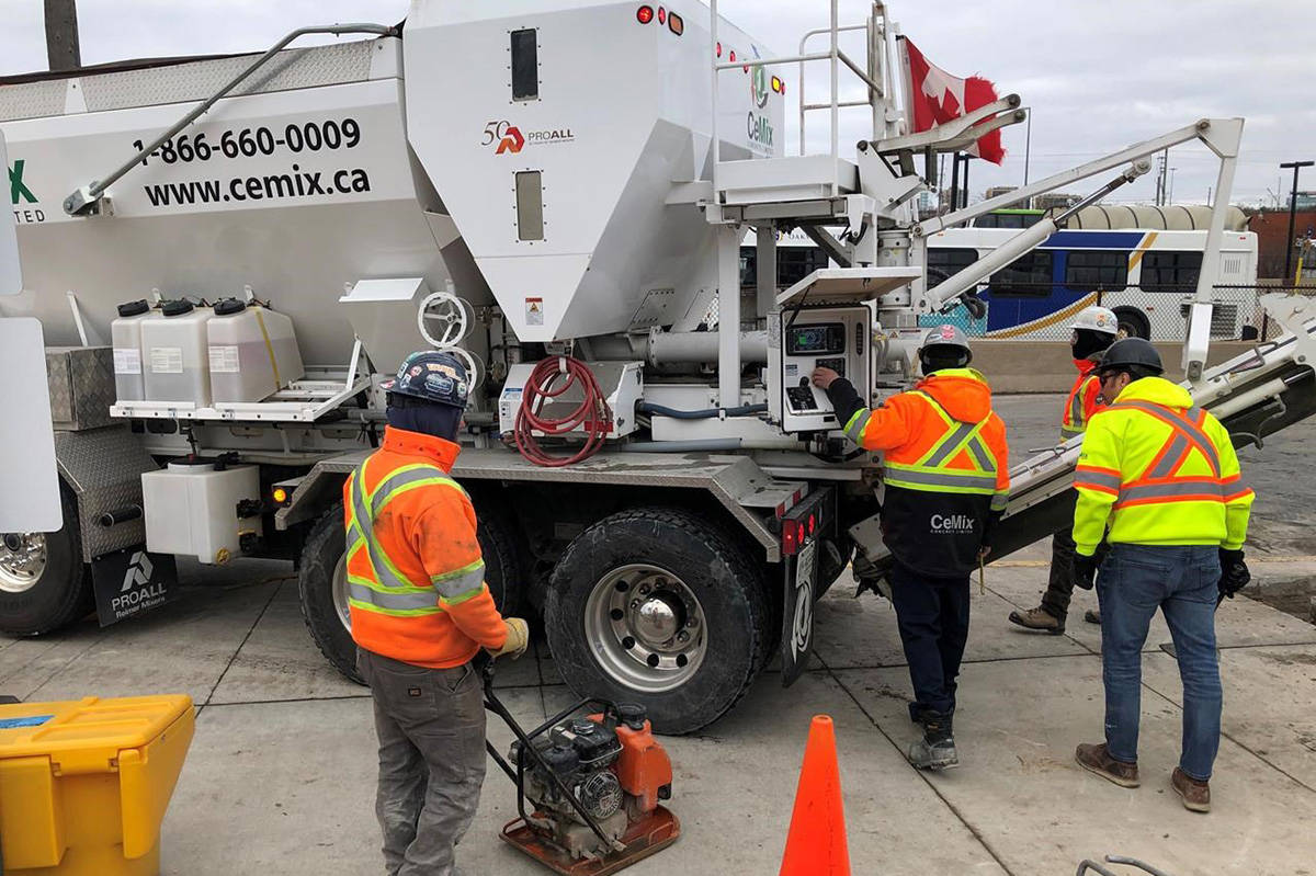 Workers get set to pour cement from a truck at the GO train station in Oakville, Ont., Tuesday, Jan.28, 2020. Statistics Canada is set today to report how many workers lost their jobs in April or had their hours slashed as a result of the COVID-19 pandemic.THE CANADIAN PRESS/Richard Buchan