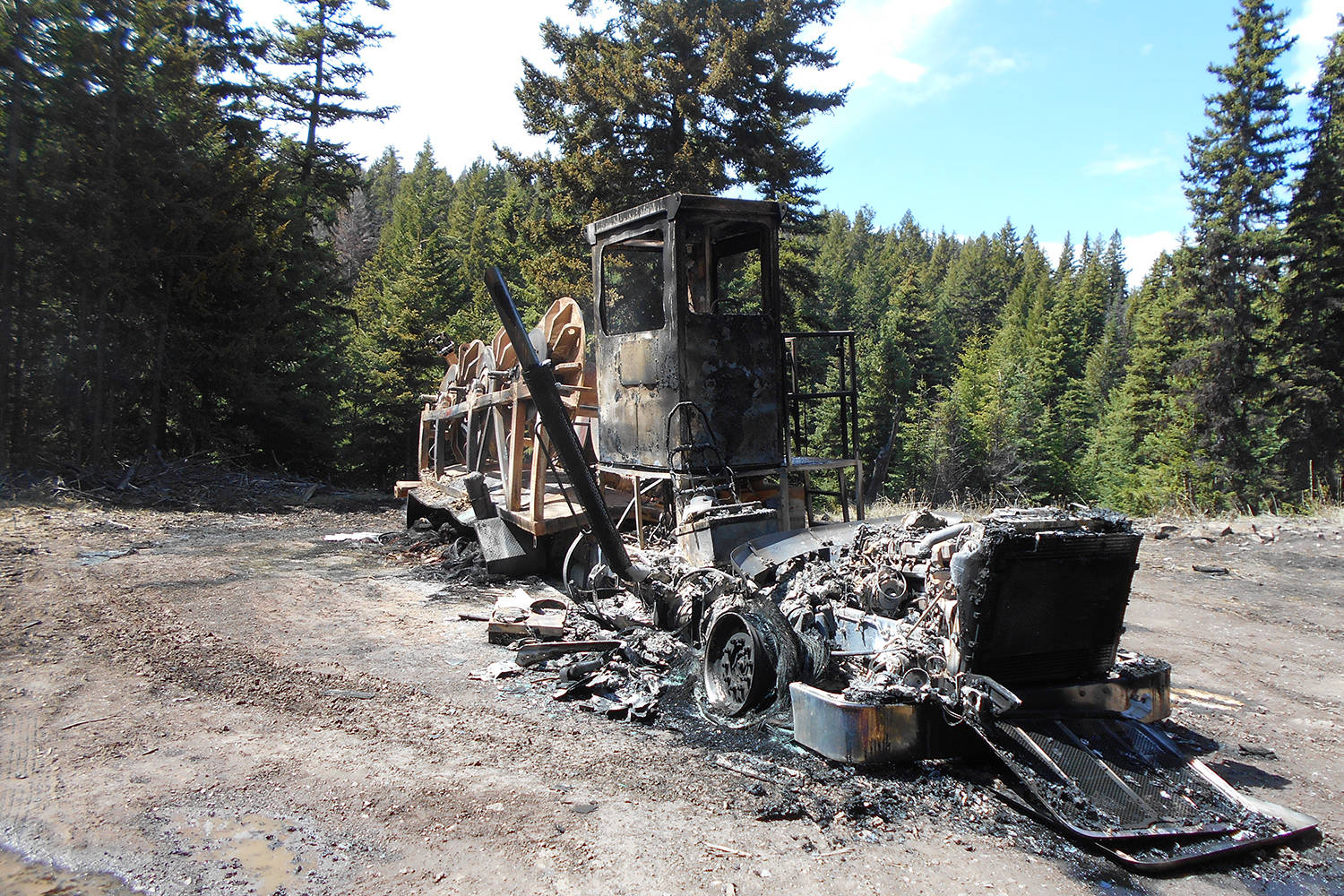 A blue Peterbilt rope truck on a Trans Mountain Expansion Project site near Merritt, B.C. was the target of an act of vandalism and theft one day and the subject of a suspicious blaze another. (Contributed)