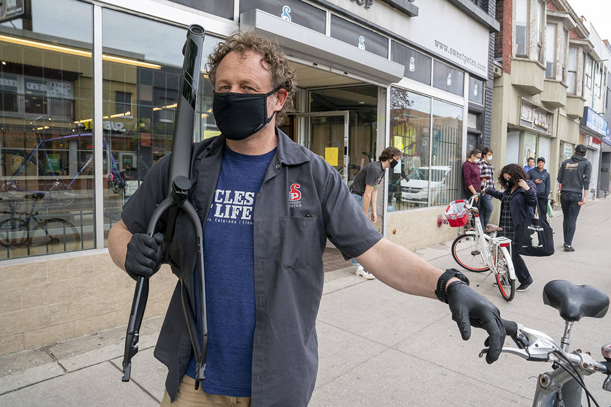 Pete Lilly of Sweet Pete’s Bike Shop poses in front of his store in Toronto on Tuesday, May 19, 2020. THE CANADIAN PRESS/Frank Gunn