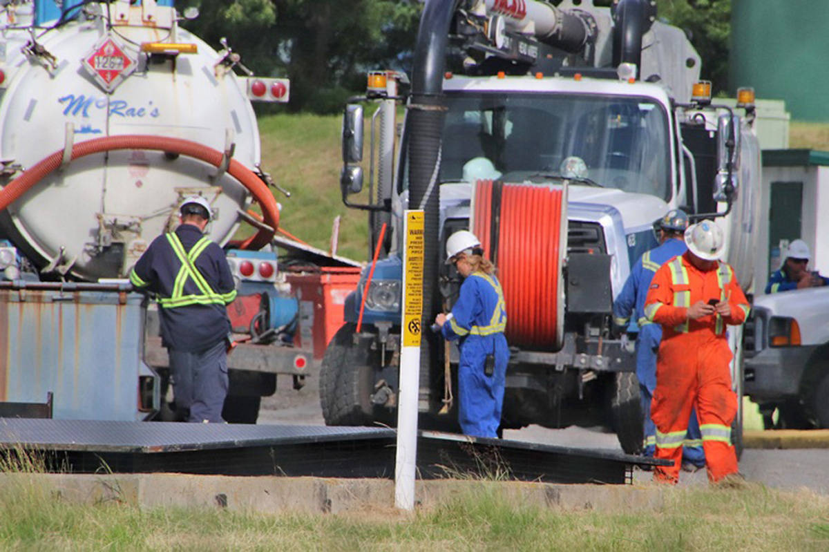 Workers clean up the oil spill in Abbotsford near Trans Mountain’s Sumas Pump Station on Saturday, June 13, 2020. (Shane MacKichan file photo)