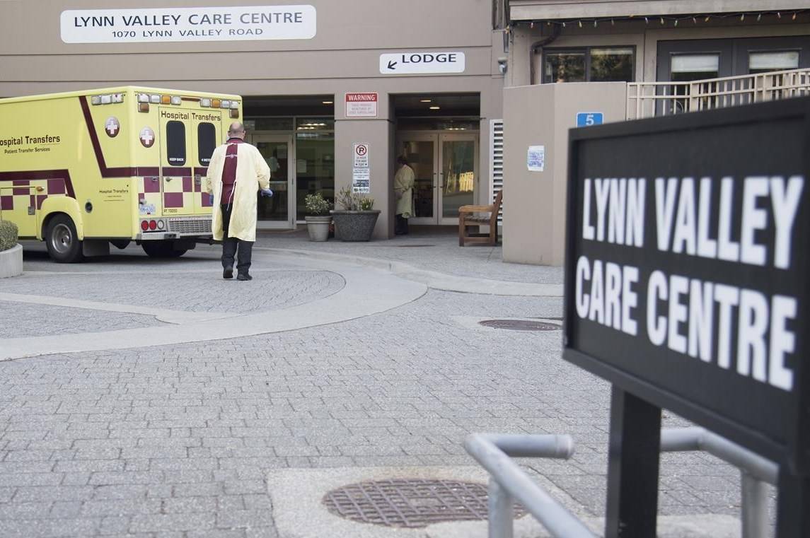 Hospital transfer workers are seen outside the Lynn Valley Centre care home in North Vancouver, B.C. on April 8, 2020. The longterm care home was among the first in B.C. to record multiple deaths due to COVID-19. THE CANADIAN PRESS/Jonathan Hayward
