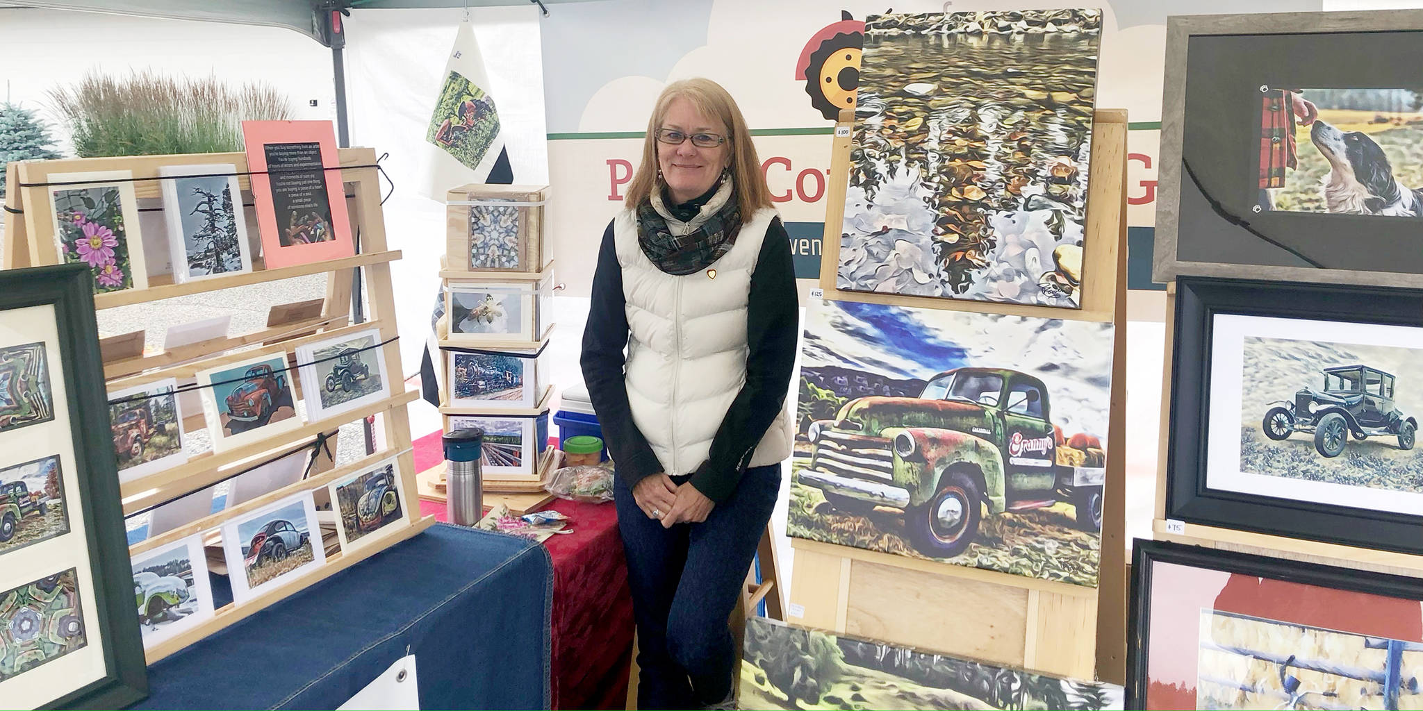 Paula Cowen shows some of her artwork at the Summerland Sunday Farmers and Crafters Market. The market opened on June 28 at the Summerland Arena parking lot. (John Arendt - Summerland Review)