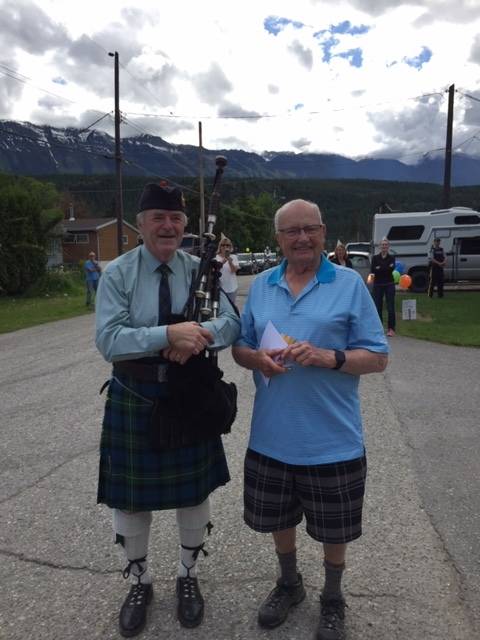 George Ross stands with Gilbert, a piper from Inverness, who came out to celebrate the 95-year-old’s birthday. (Contributed)