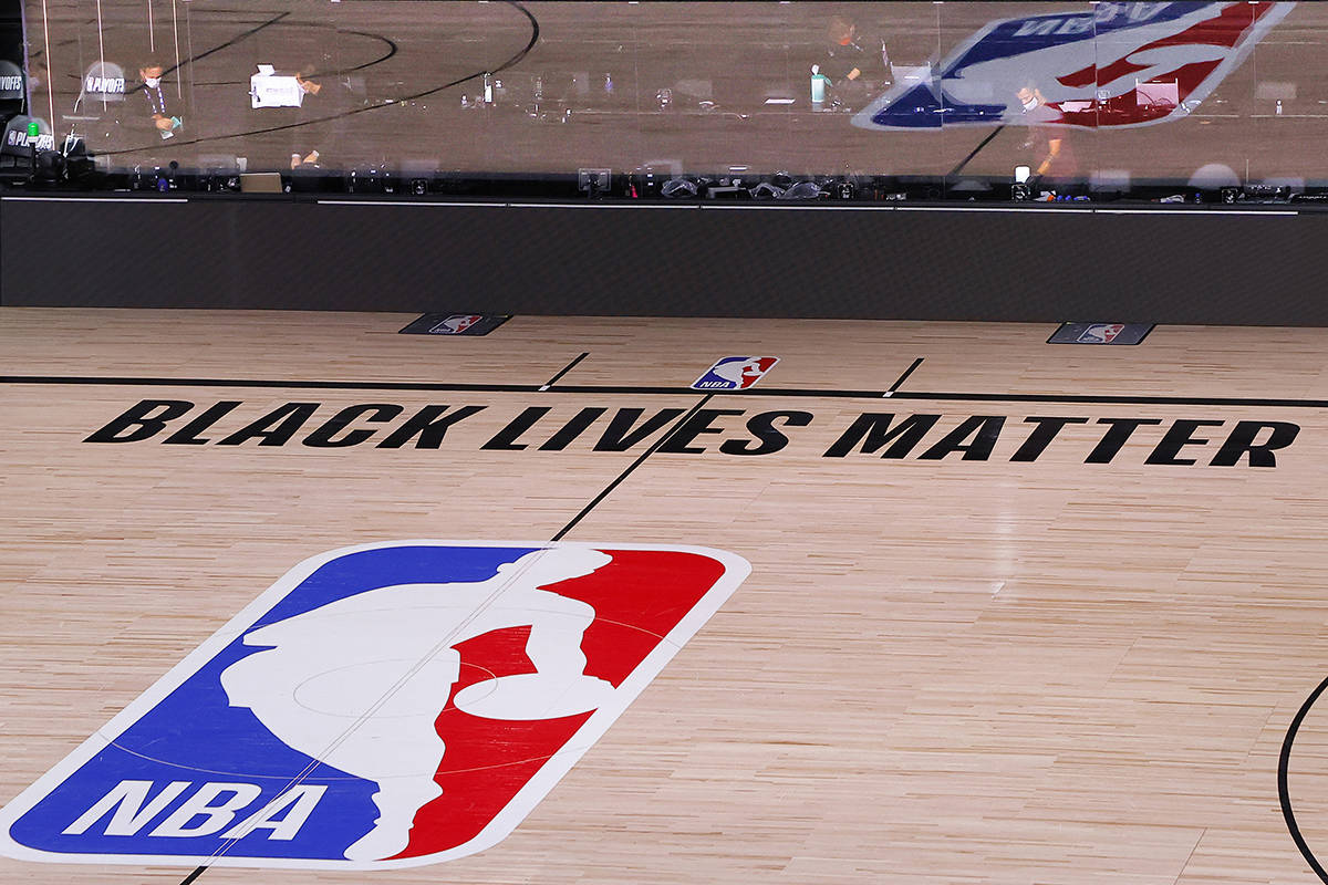 An empty court and bench are shown with no signage following the scheduled start time in Game 5 of an NBA basketball first-round playoff series, Wednesday, Aug. 26, 2020, in Lake Buena Vista, Fla. NBA players made their strongest statement yet against racial injustice Wednesday when the Milwaukee Bucks didn’t take the floor for their playoff game against the Orlando Magic.(Kevin C. Cox/Pool Photo via AP)