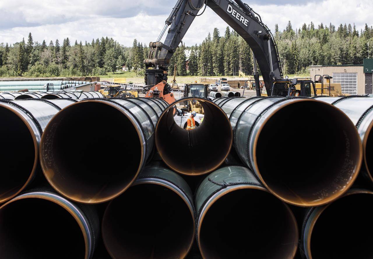 Pipe for the Trans Mountain pipeline is unloaded in Edson, Alta. on Tuesday, June 18, 2019. Statistics Canada says that capital spending in the Canadian oil and gas sector fell by 54 per cent in the second quarter ended June 30, as oil prices fell due to a global price war and demand destruction caused by the COVID-19 pandemic. THE CANADIAN PRESS/Jason Franson