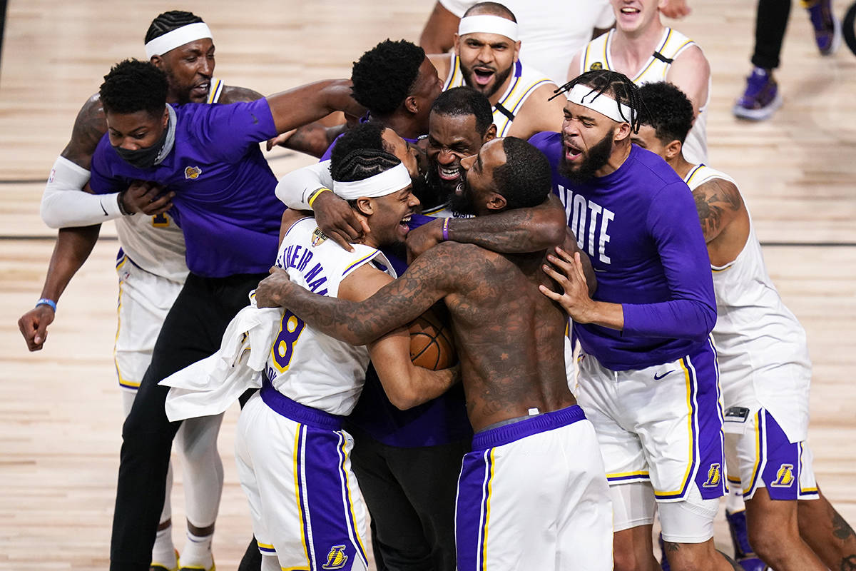 The Los Angeles Lakers players celebrate after the Lakers defeated the Miami Heat 106-93 in Game 6 of basketball’s NBA Finals Sunday, Oct. 11, 2020, in Lake Buena Vista, Fla. (AP Photo/John Raoux)
