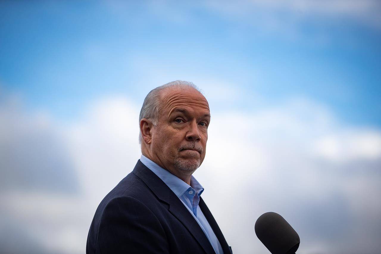 NDP Leader John Horgan pauses while responding to questions during a campaign stop, in Vancouver, on Monday, October 12, 2020. A provincial election will be held in British Columbia on October 24. THE CANADIAN PRESS/Darryl Dyck