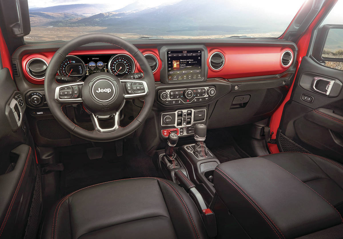 The dash layout of the Gladiator looks like that of any other Wrangler, which is to say it’s a busy spot. Note that one shift lever is for the transmission and the other is for operating the transfer case for high-low gear range. PHOTO: FCA