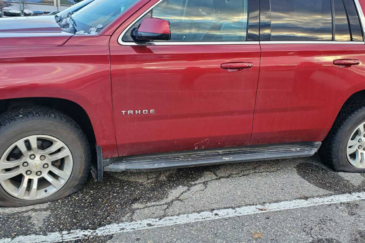 This Chevrolet Tahoe SUV allegedly had the tires on its driver’s side punctured by an unknown individual at the Village Green Shopping Centre parking lot Wednesday, Nov. 11. The vehicle had a Saskatchewan licence plate, but the owner lives in Vernon. (Kerry Hutter photo)