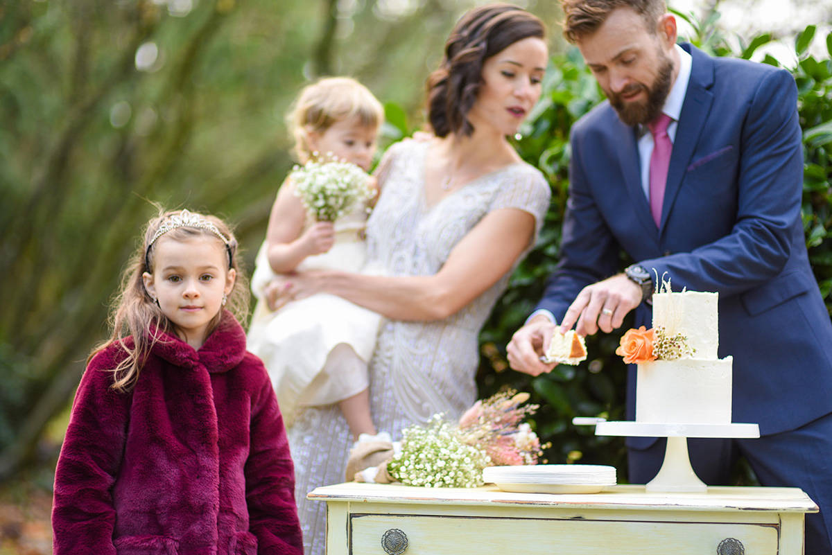 After twice have their wedding plans altered due to COVID-19 restrictions, Suzanne Schmidt and Andrew Sturgess got married in Bakerview Park last weekend, with the only guests being their two daughters, Zoey (foreground) and Tessa. (Darren Ripka photo)