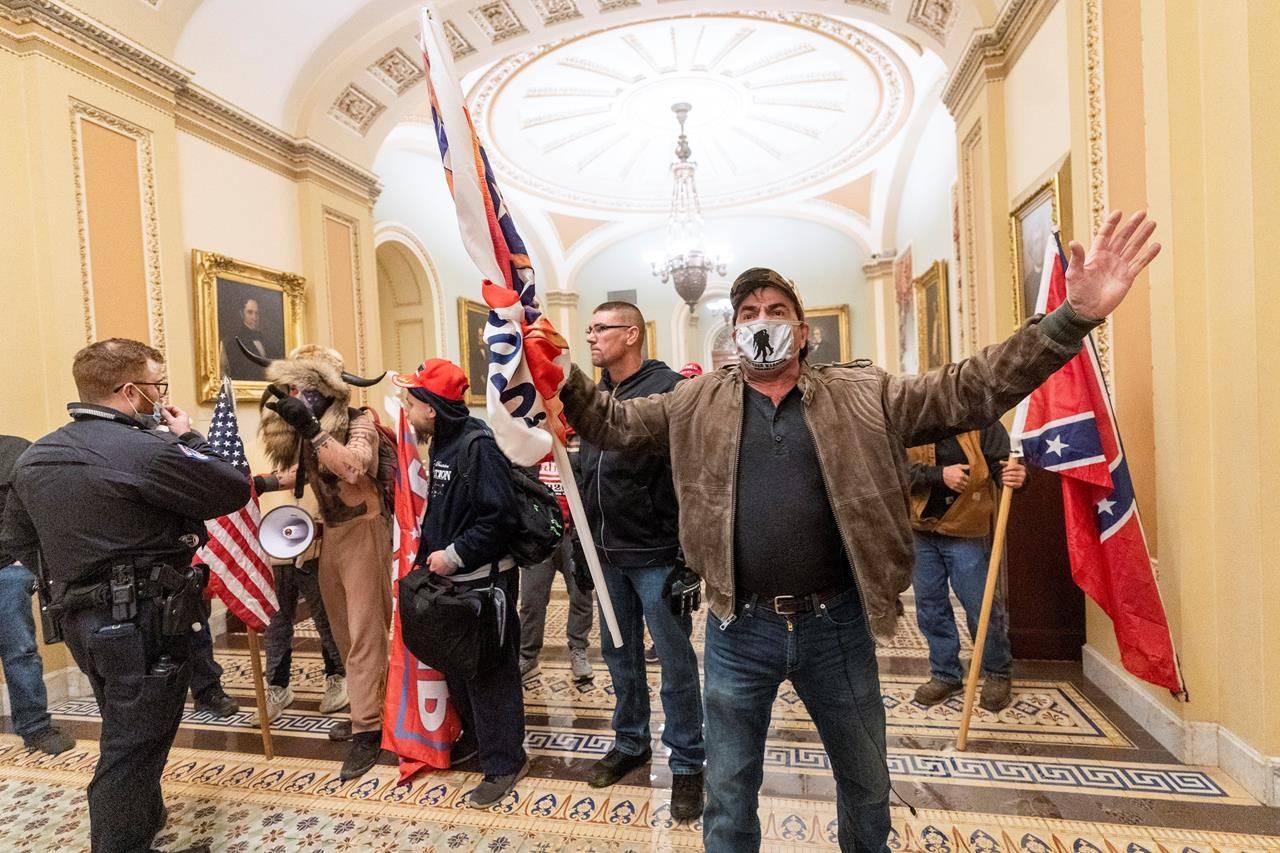 Supporters of President Donald Trump are confronted by U.S. Capitol Police officers outside the Senate Chamber inside the Capitol, in Washington, Wednesday, Jan. 6, 2021. The storming of Capitol Hill in Washington by right-wing extremists earlier this month has spurred calls for Canada to add groups such as the Proud Boys and The Base to its terror list. THE CANADIAN PRESS/AP-Manuel Balce Ceneta