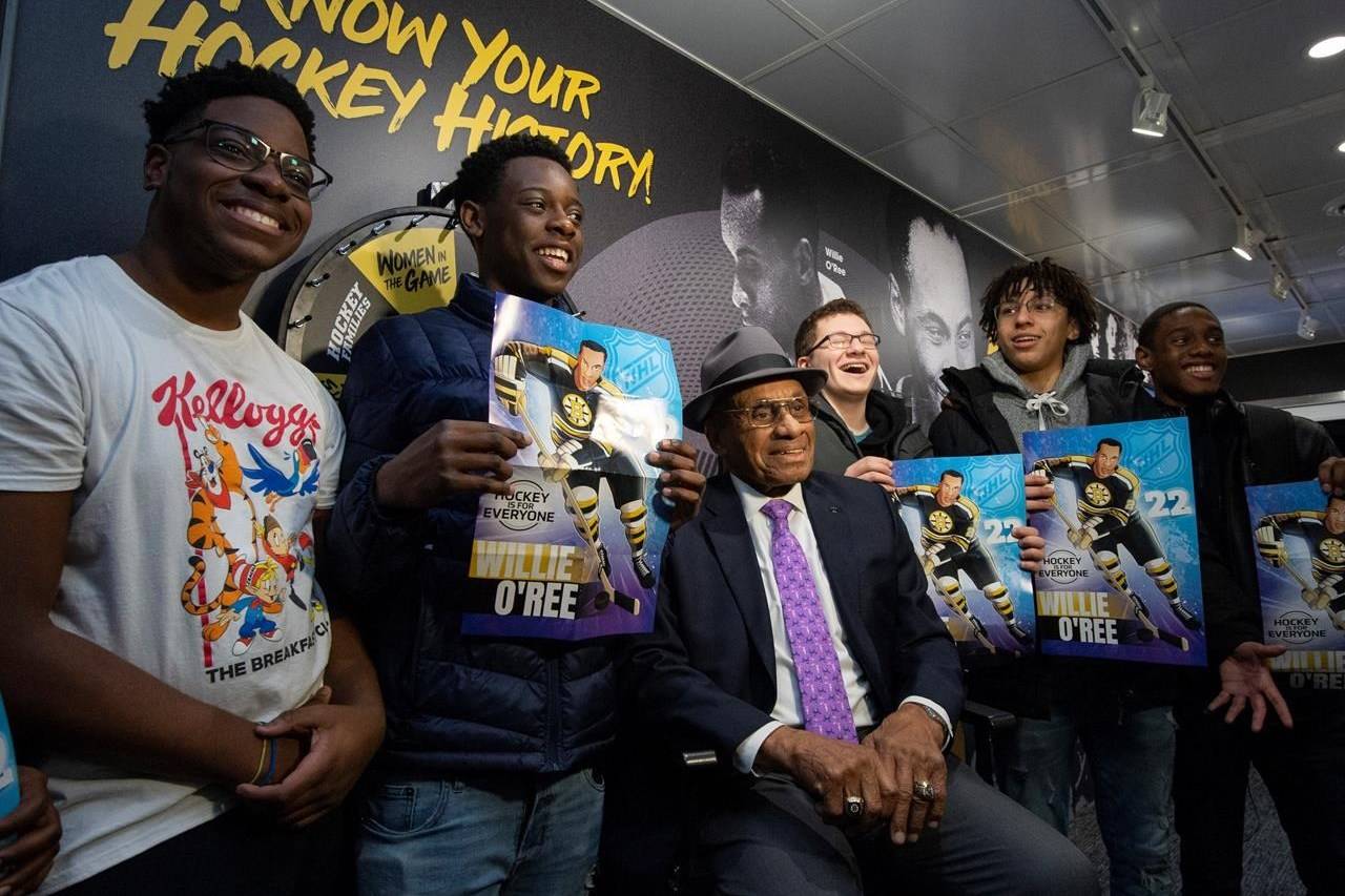 Willie O’Ree, the first black player in the NHL and member of the Hockey Hall of Fame, sits for a photo with students from St. Peter’s High School in the NHL’s Black Hockey History Mobile Museum, an initiative for Black History Month, in Ottawa, on February 3, 2020. THE CANADIAN PRESS/Justin Tang