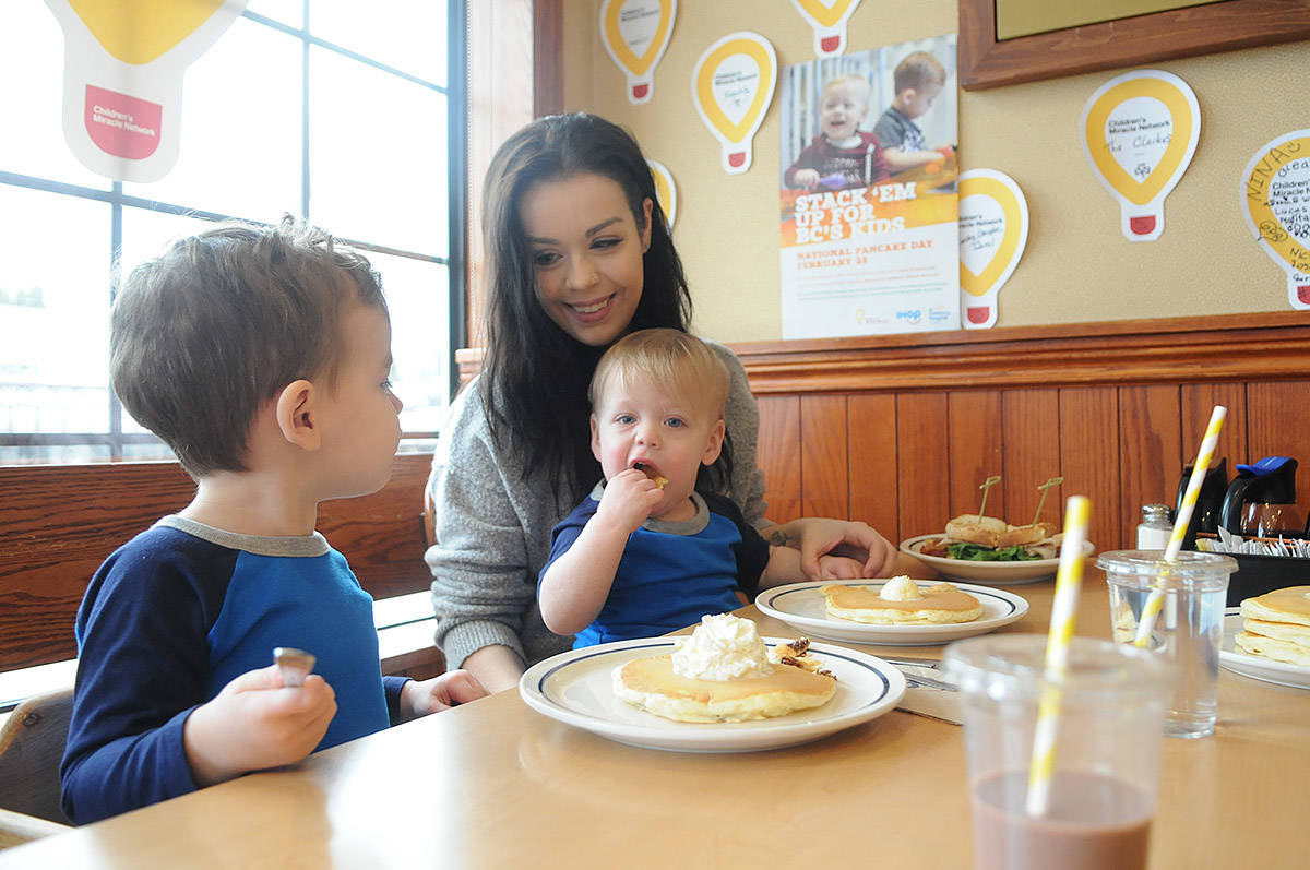 Sauyer Bell sits on mom Shae’s lap while having pancakes with her and his two-year-old brother Graeson at IHOP in Chilliwack on Tuesday, Feb. 25, 2020. This photo was taken when Sauyer, who is a BC Children’s Hospital patient, was the face on the poster for IHOP’s National Pancake Day fundraiser for the hospital last year. (Jenna Hauck/ Chilliwack Progress file)