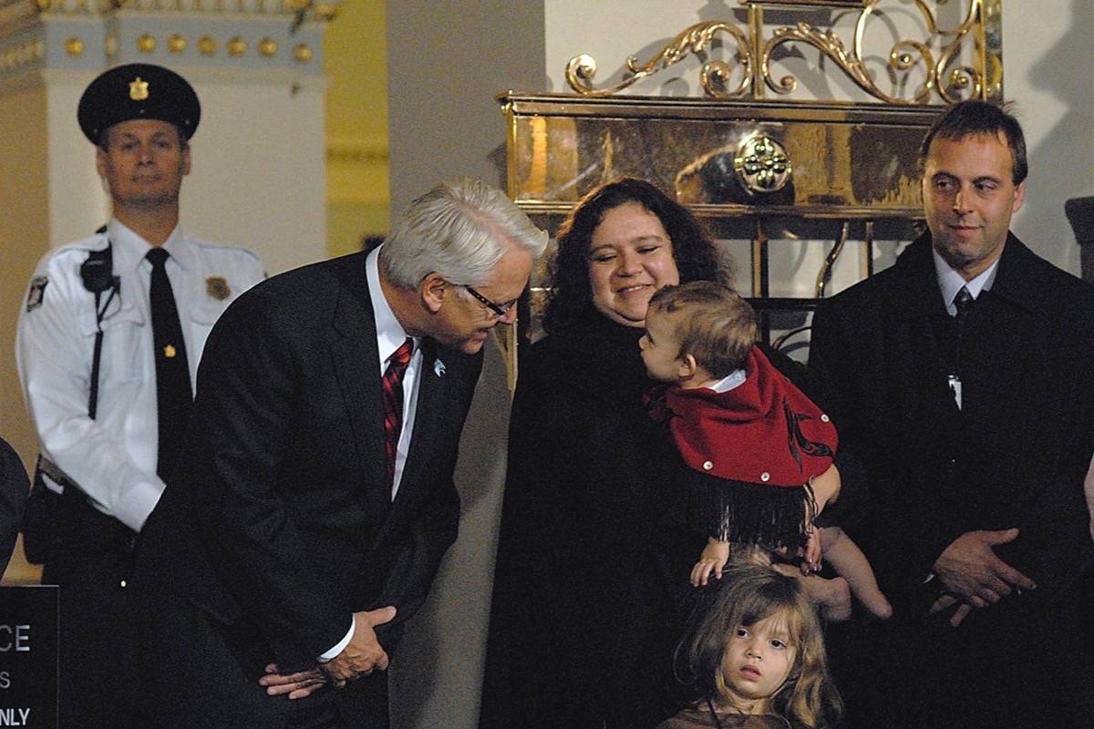 B.C. Premier Gordon Campbell gets acquainted with Tsawwassen First Nation Chief Kim Baird’s 10-month-old daughter Sophia, husband Steve and four-year-old Amy at the B.C. legislature before a ceremony to endorse the Tsawwassen Treaty, Oct. 15, 2007. (Sharon Tiffin/Black Press)
