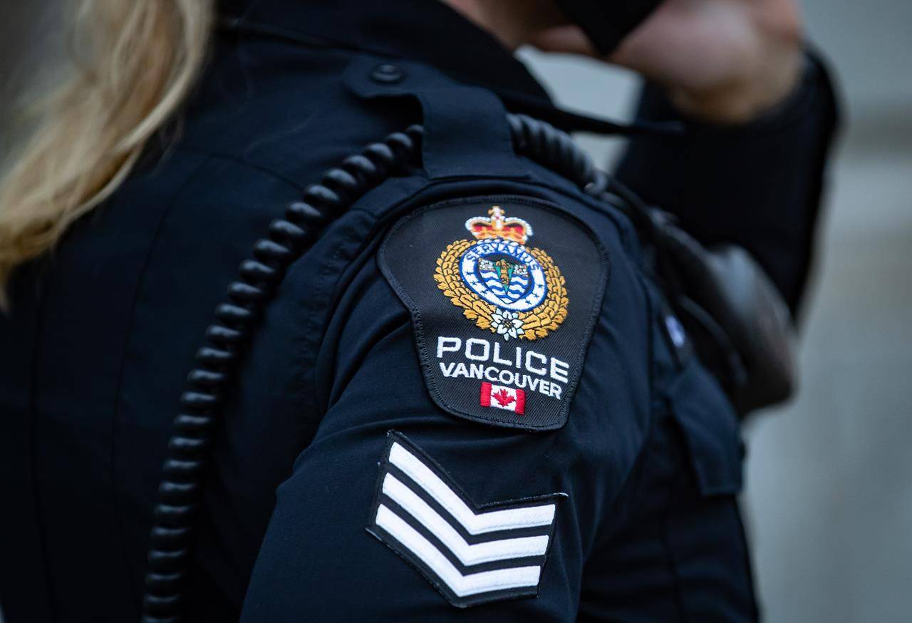 A Vancouver Police Department patch is seen on an officer’s uniform as she makes a phone call after responding to an unknown incident in the Downtown Eastside of Vancouver, on January 9, 2021. THE CANADIAN PRESS/Darryl Dyck