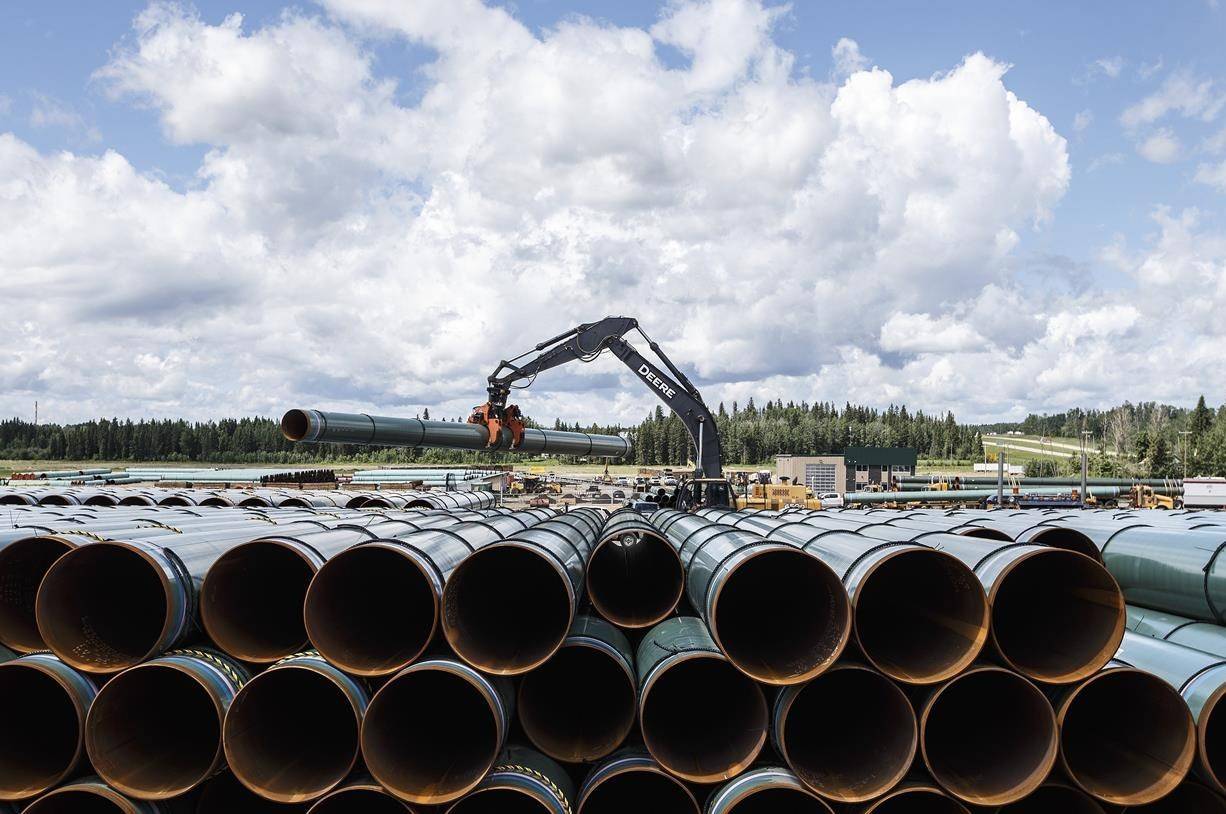 Pipe sections for the Trans Mountain pipeline are unloaded in Edson, Alta., Tuesday, June 18, 2019. North America’s polarizing pipeline battles have seen many venues — from the Prime Minister’s Office and the U.S. State Department to the windswept plains of Nebraska and Minnesota to judge’s chambers on both sides of the Canada-U.S. border. THE CANADIAN PRESS/Jason Franson
