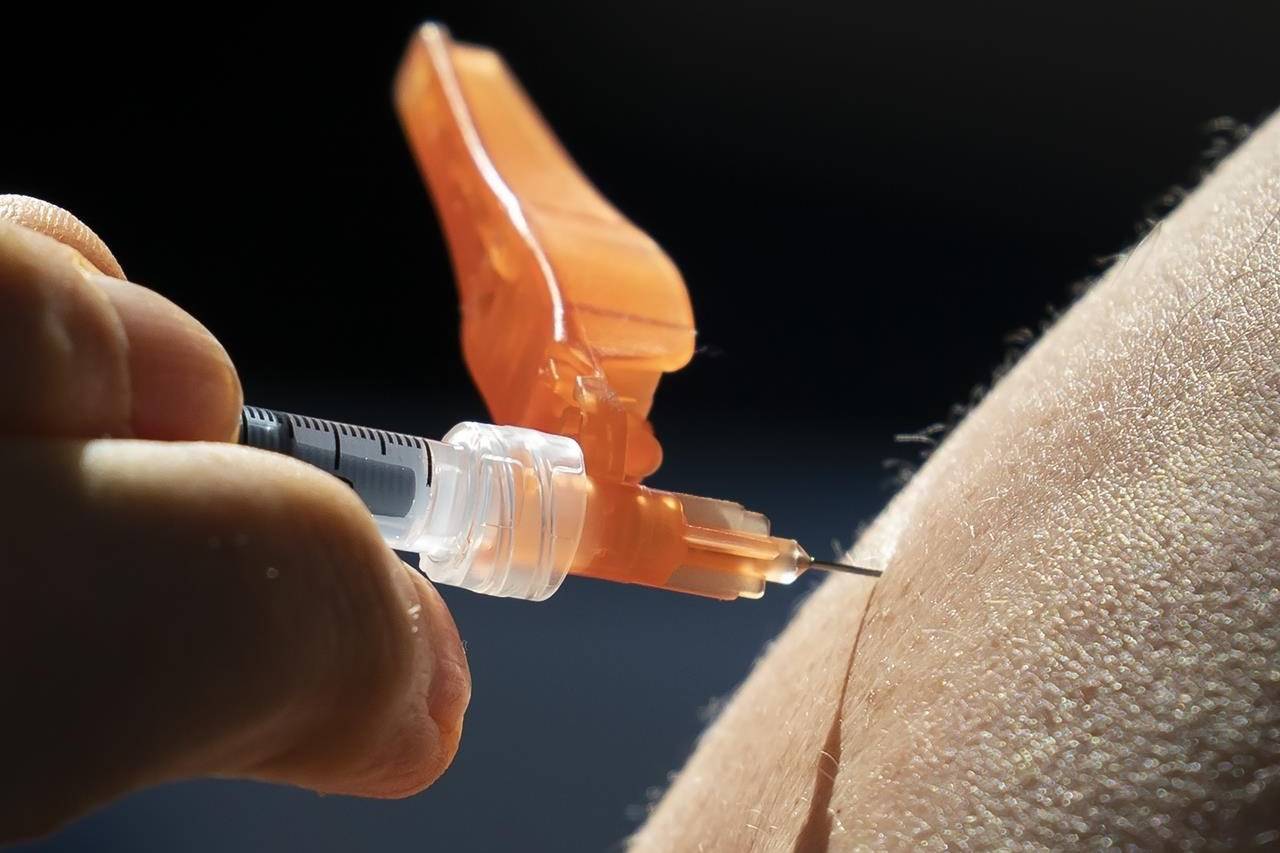 A dose of the Pfizer-BioNTech COVID-19 vaccine is given to a recipient at a vaccination site in Vancouver on March 11, 2021. THE CANADIAN PRESS/Jonathan Hayward