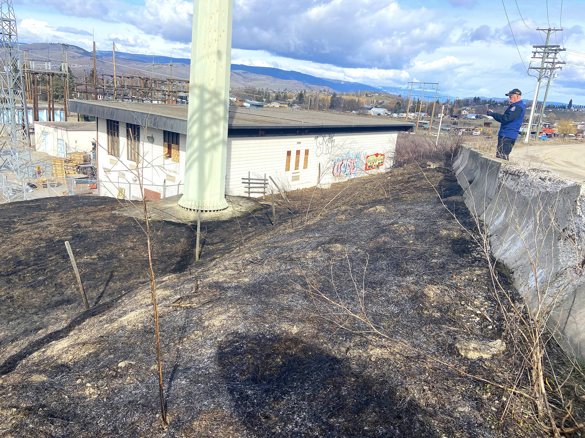 BX-Swan Lake fire chief Bill Wacey investigates a suspicious grass fire, which was sparked next to the BC Hydro substation early Monday, March 22, 2021. (Jennifer Smith - Morning Star)