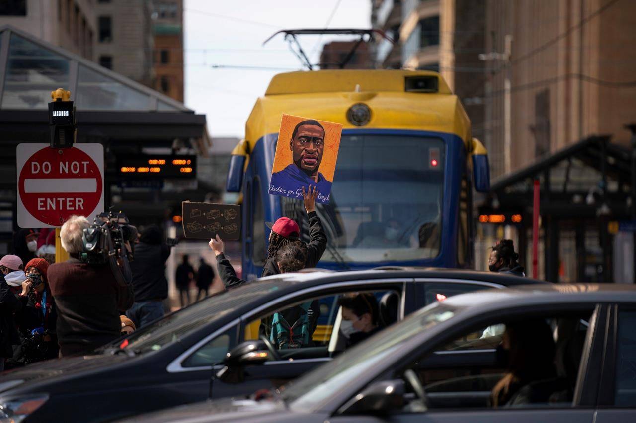 A light rail train is blocked briefly by demonstrators next to the plaza at Hennepin County Government Center on the eve of the start of the trial of Derek Chauvin in the killing of George Floyd, Sunday, March 28, 2021, in Minneapolis. (Jeff Wheeler/Star Tribune via AP)
