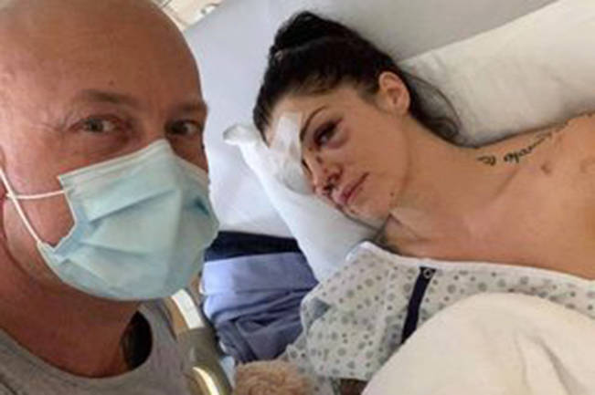 Jason Culley at the bedside of his partner Regina Hampson, who was shot in the face while intervening in a mental health crisis in a north Nanaimo home on Saturday. (Photo submitted)