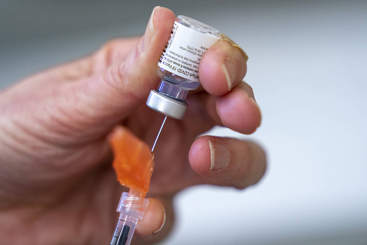 A syringe is loaded with COVID-19 vaccine at a vaccination clinic run by Vancouver Coastal Health, in Richmond, B.C., Saturday, April 10, 2021. THE CANADIAN PRESS/Jonathan Hayward
