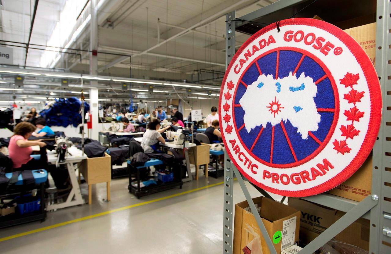 Employees work with Canada Goose jackets at the Canada Goose factory in Toronto on Thursday, April 2, 2015. THE CANADIAN PRESS/Nathan Denette